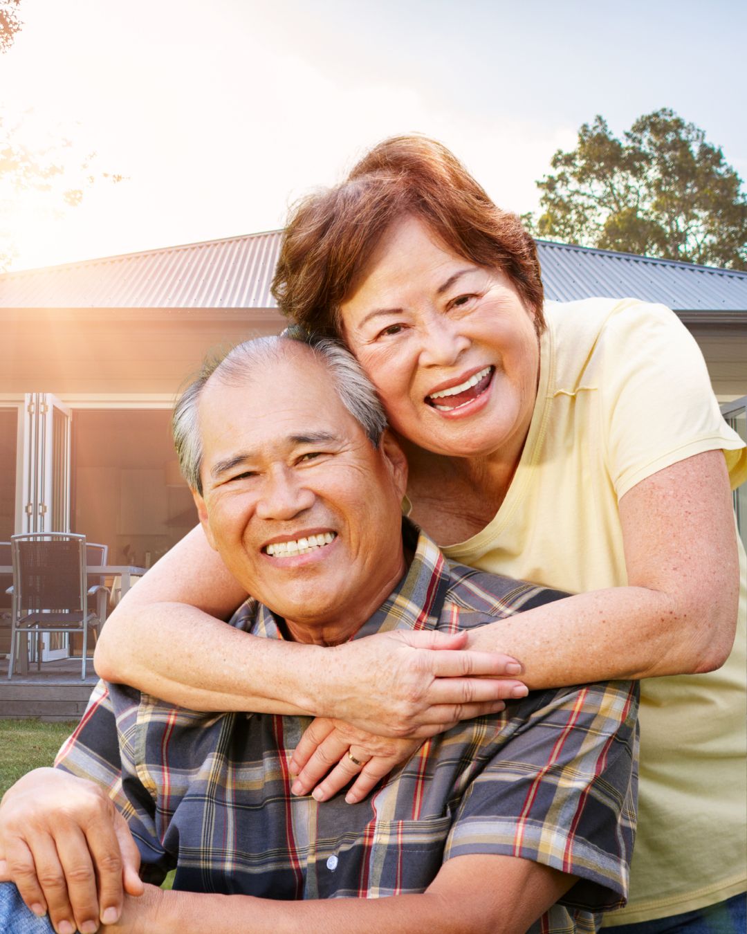 A couple sitting together on a white background.