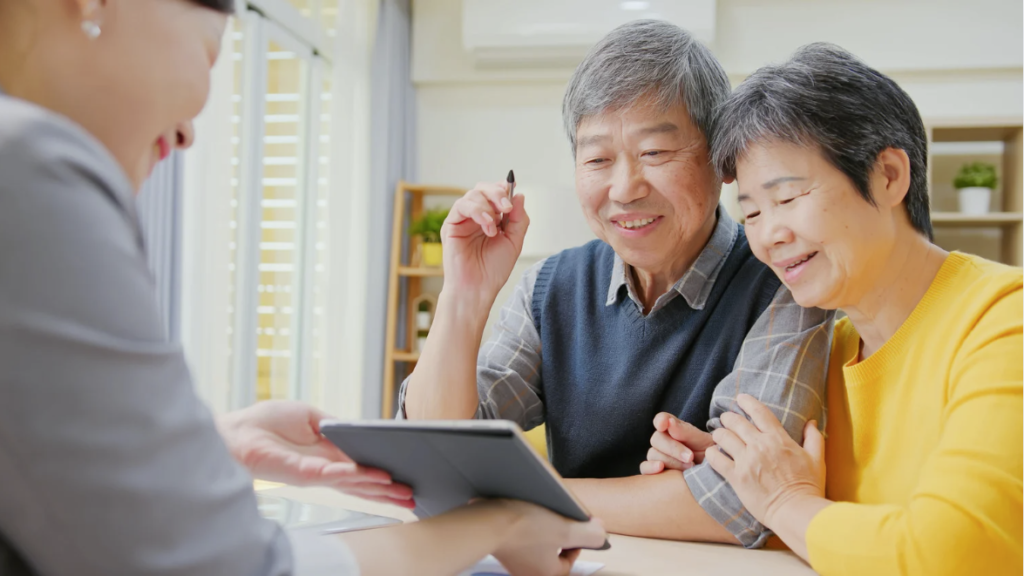 A couple looking at a tablet computer.